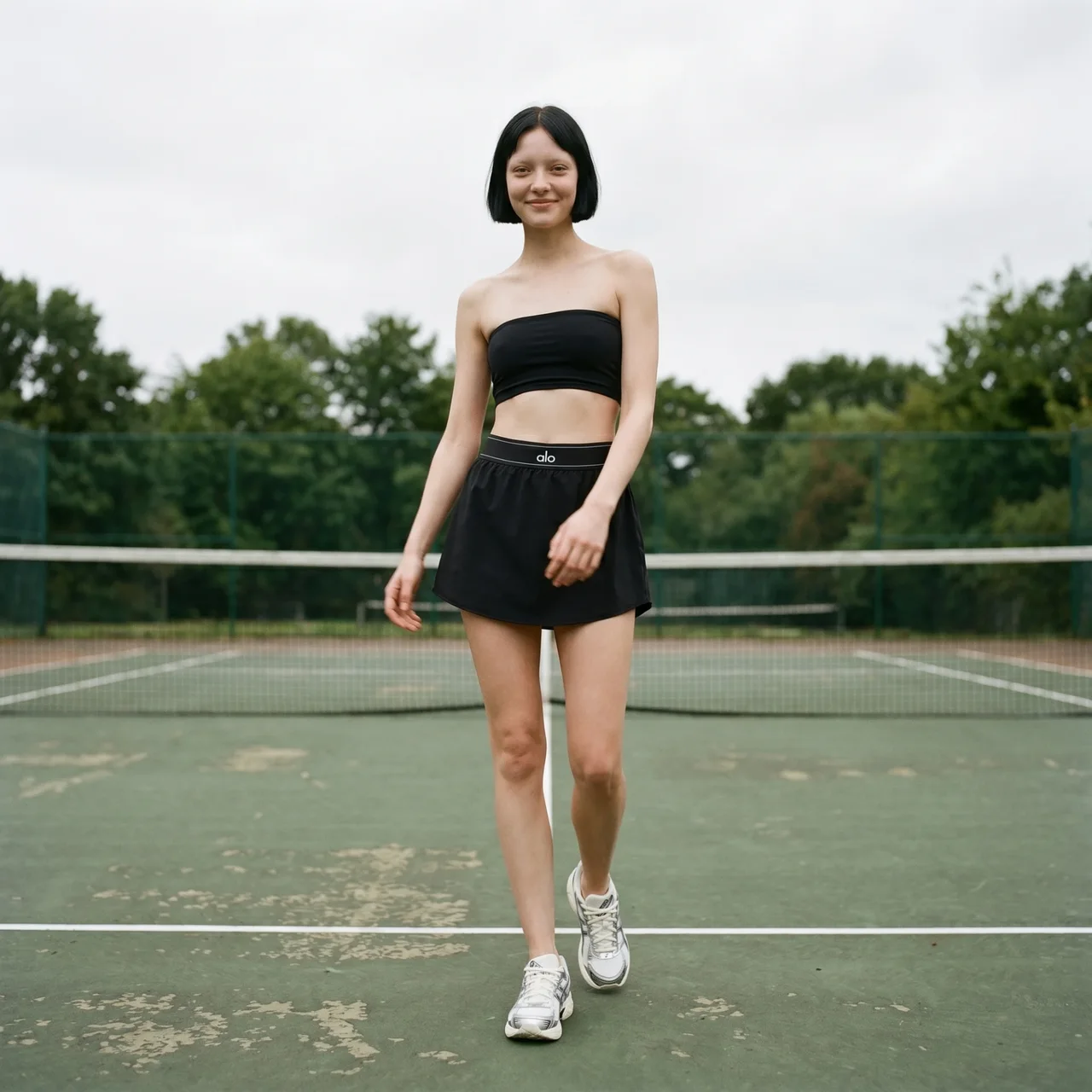 Nomiki fashion imagery on a tennis court.